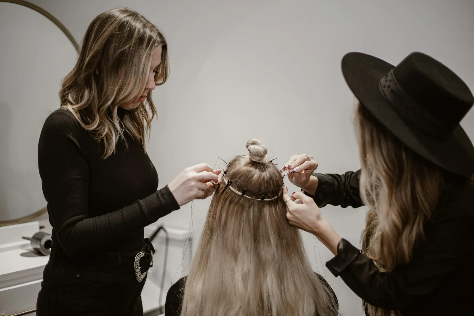 a woman getting her hair styled by another woman a woman getting her hair styled by another woman